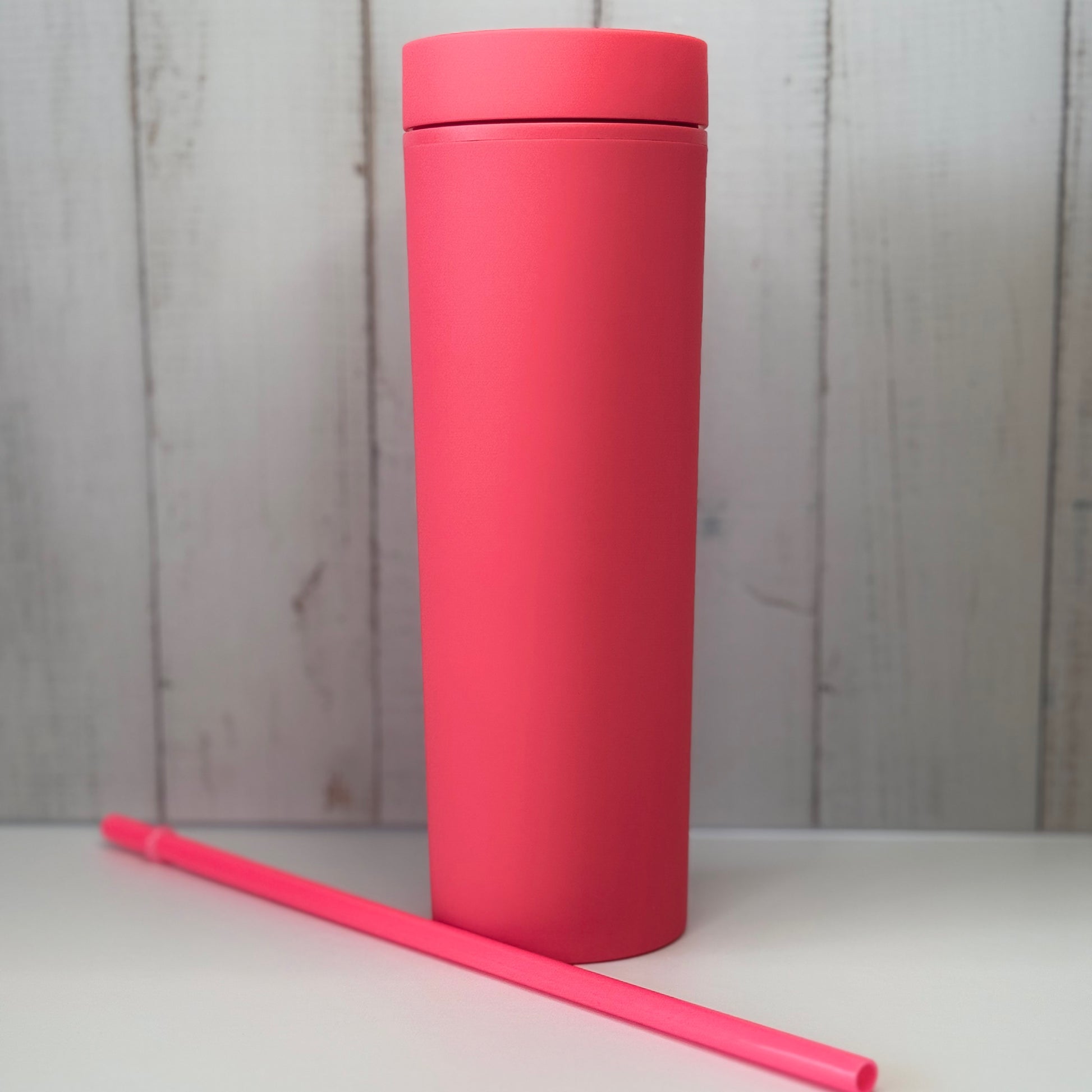 Bright pink tumbler with straw