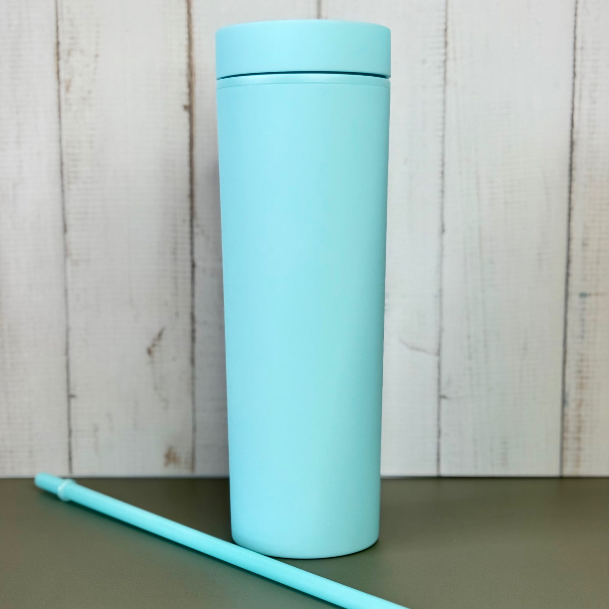 Light blue matte tumbler with straw for iced coffee