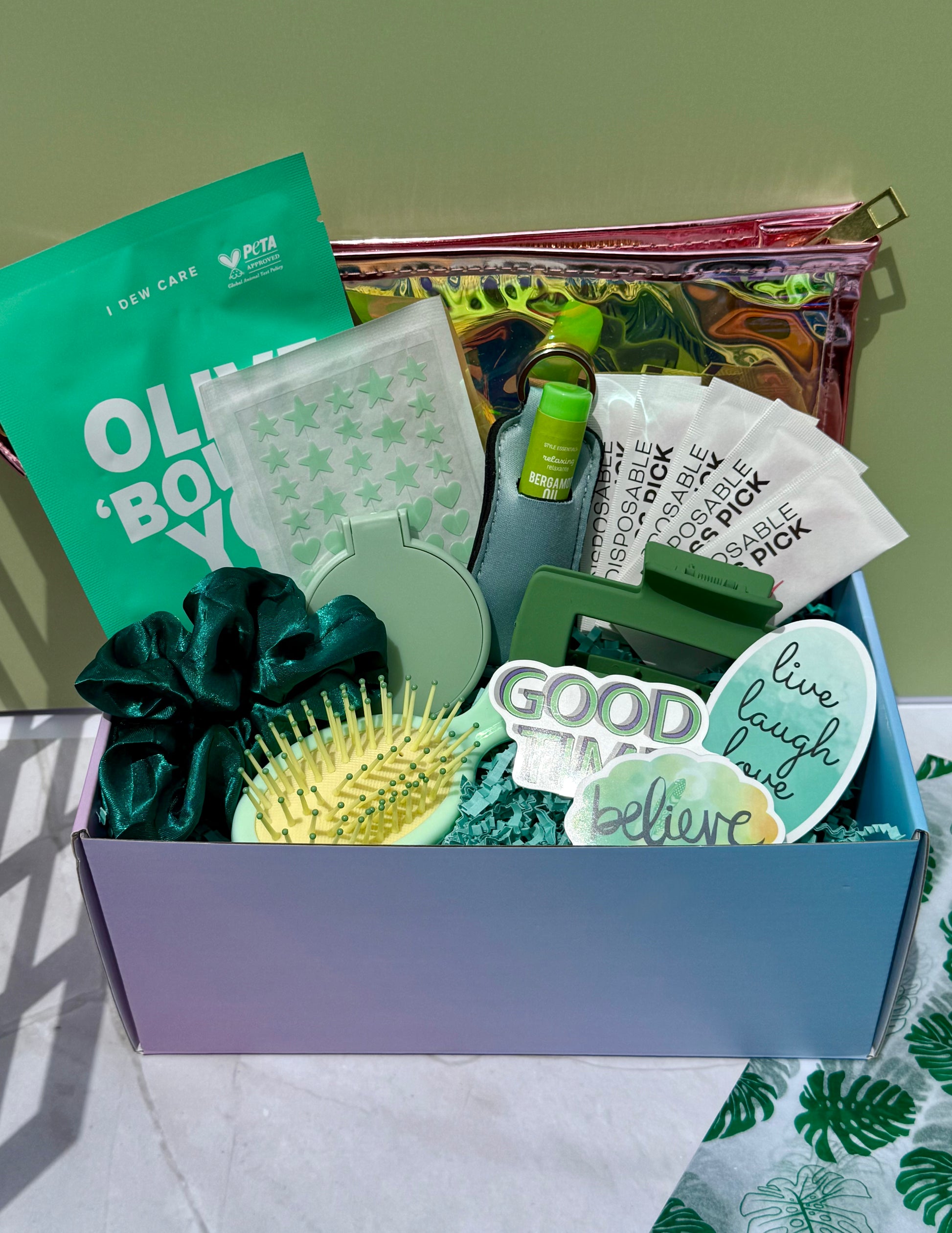 Green and mint themed wellness gift box with much needed beauty essentials including face mask, make-up bag, mini hair brush