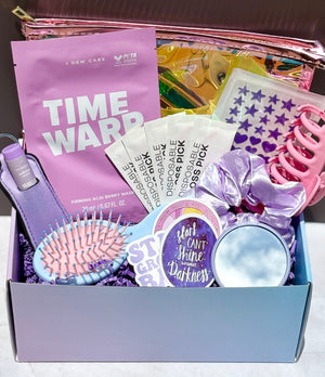Purple-themed self care gift box with beauty items, pimple patches, scrunchie, and face masks 
